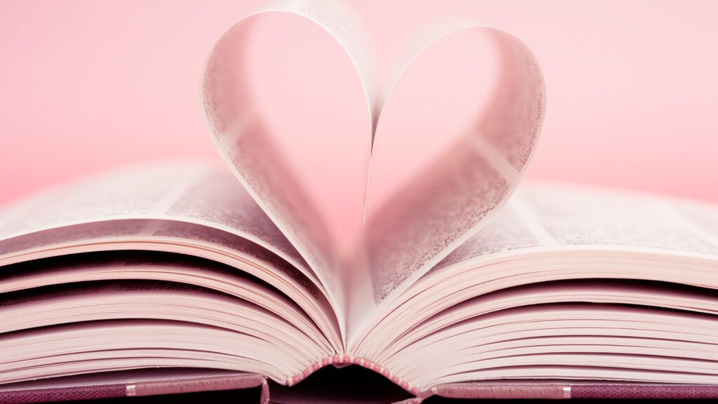 An open book with a heart shape made from its pages, representing the love for literature and the written word."