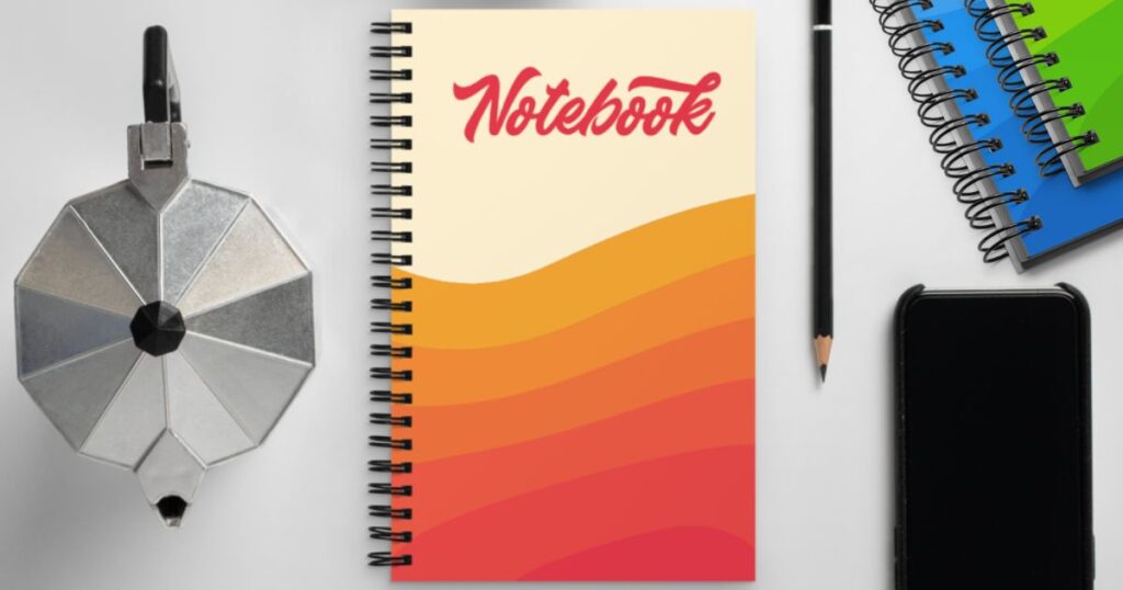 A notebook with bold shades of orange on a desk